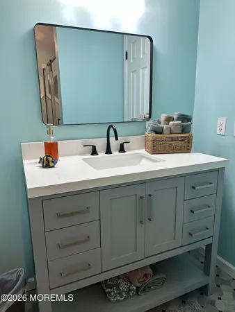 a bathroom with a sink and a mirror