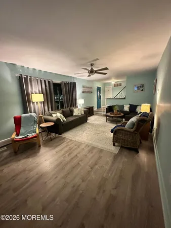 a living room with furniture gym equipment and a large window