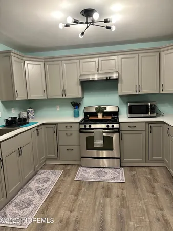 a kitchen with stainless steel appliances granite countertop a sink and cabinets