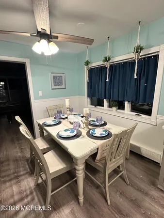 a dining room with furniture and a mirror