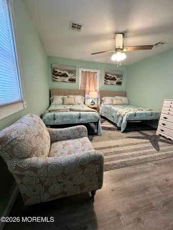 a living room with furniture and a ceiling fan