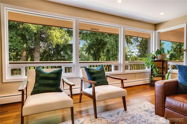 a balcony with furniture and a large window
