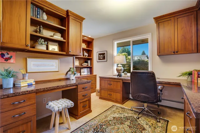 a room with a desk and chair with wooden floor