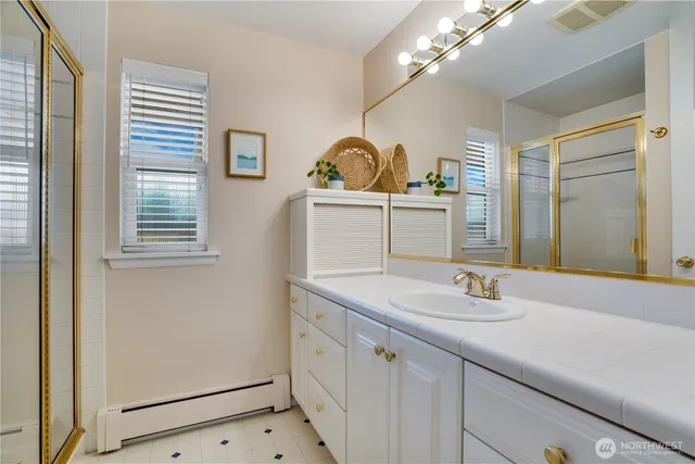 a bathroom with a sink a mirror and a window