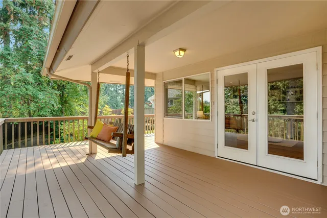a view of balcony with floor to ceiling windows with wooden floor