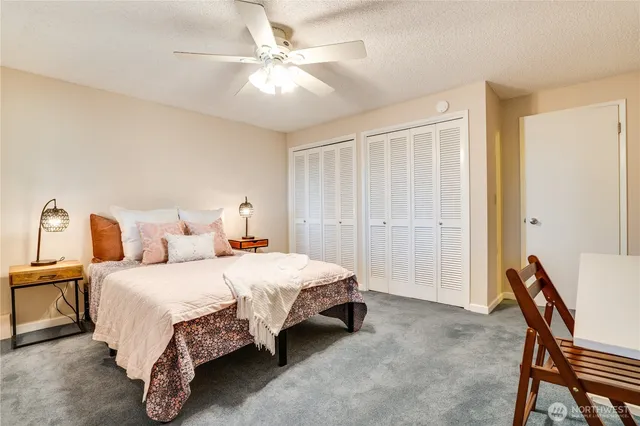 a bathroom with a granite countertop sink mirror vanity and toilet