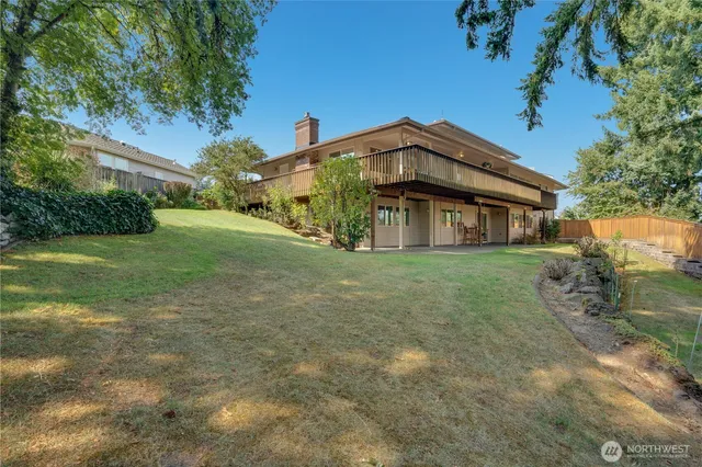 a view of a hall with wooden floor and furniture