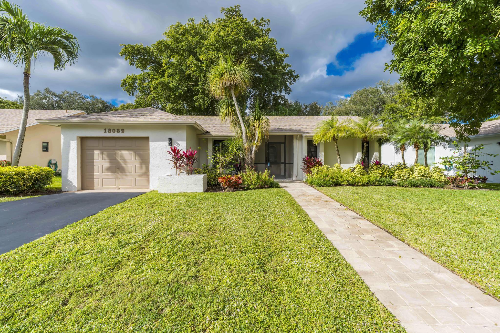 18089 103rd Trail South Boca Raton, FL 33498 - Photo 1 of 51 a front view of house with yard and green space