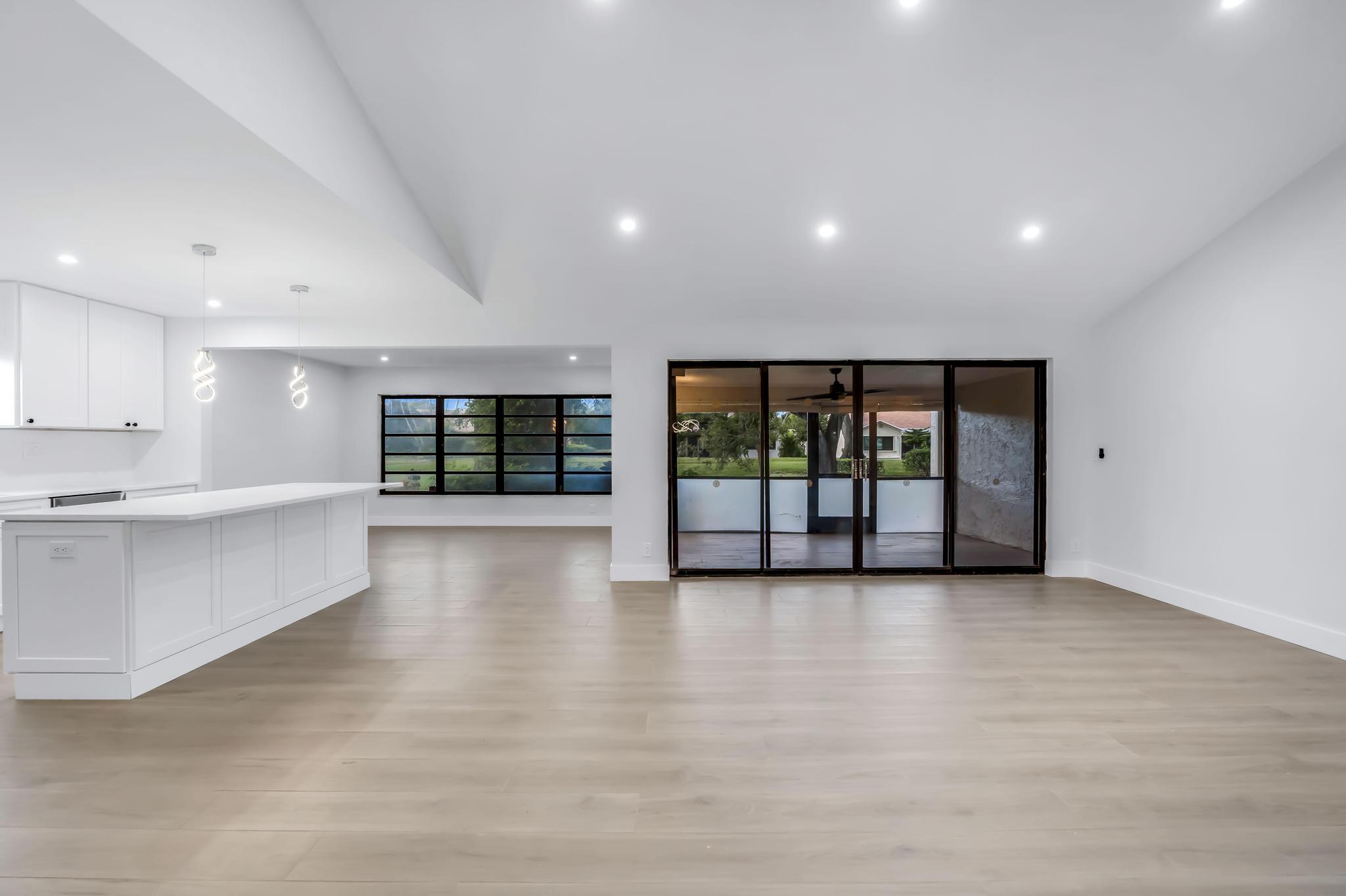 18089 103rd Trail South Boca Raton, FL 33498 - Photo 12 of 51 a view of an empty room with wooden floor and a window