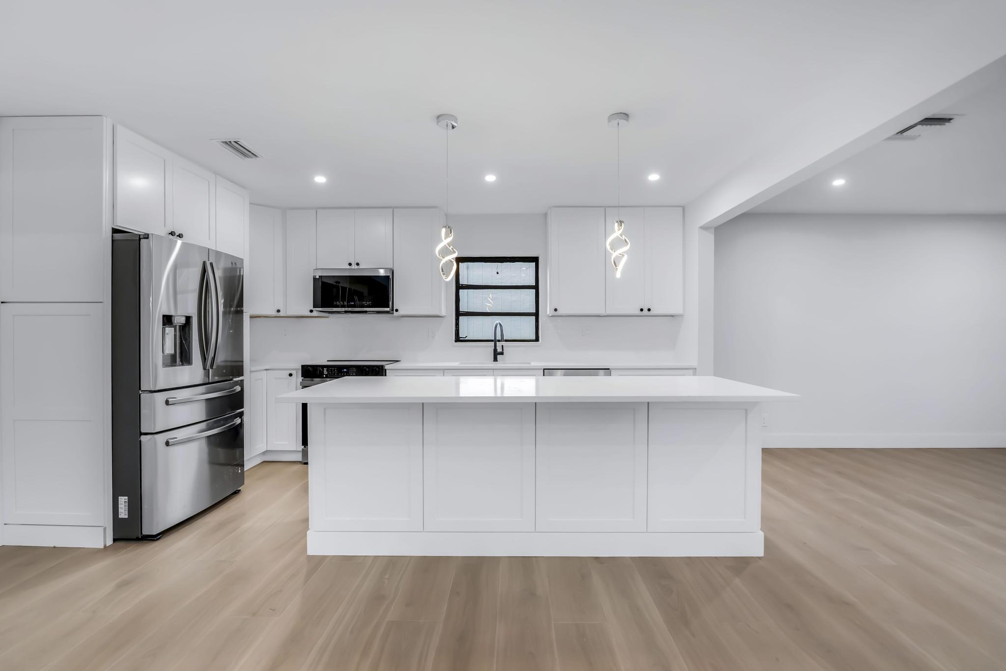 18089 103rd Trail South Boca Raton, FL 33498 - Photo 14 of 51 a kitchen with stainless steel appliances a refrigerator and a stove top oven
