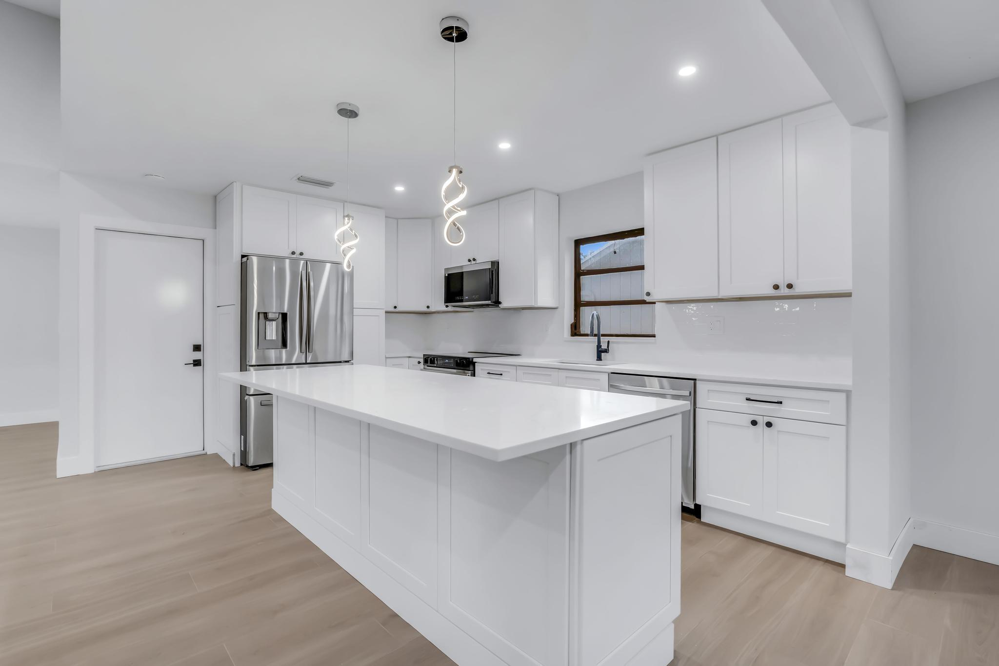 18089 103rd Trail South Boca Raton, FL 33498 - Photo 15 of 51 a kitchen with stainless steel appliances sink refrigerator and microwave