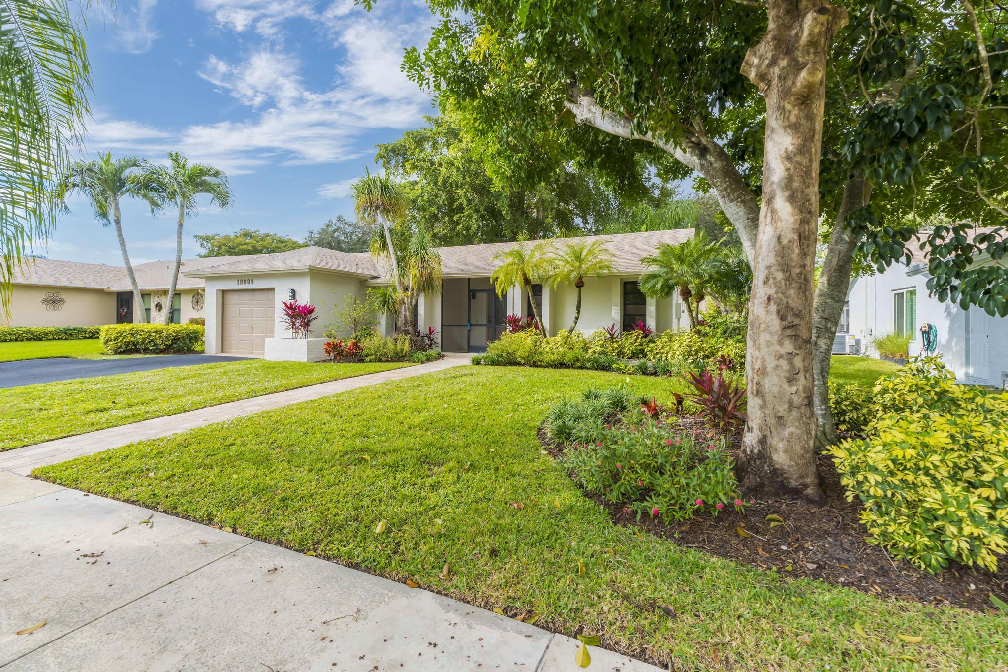 18089 103rd Trail South Boca Raton, FL 33498 - Photo 2 of 51 a front view of a house with garden