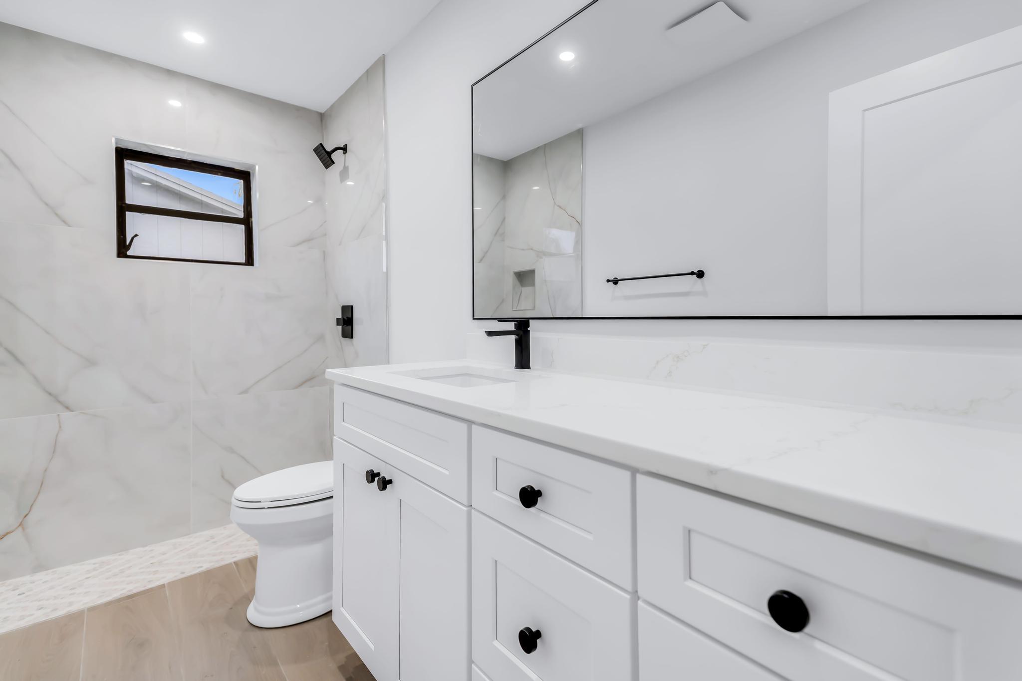 18089 103rd Trail South Boca Raton, FL 33498 - Photo 25 of 51 a bathroom with a sink a toilet and mirror