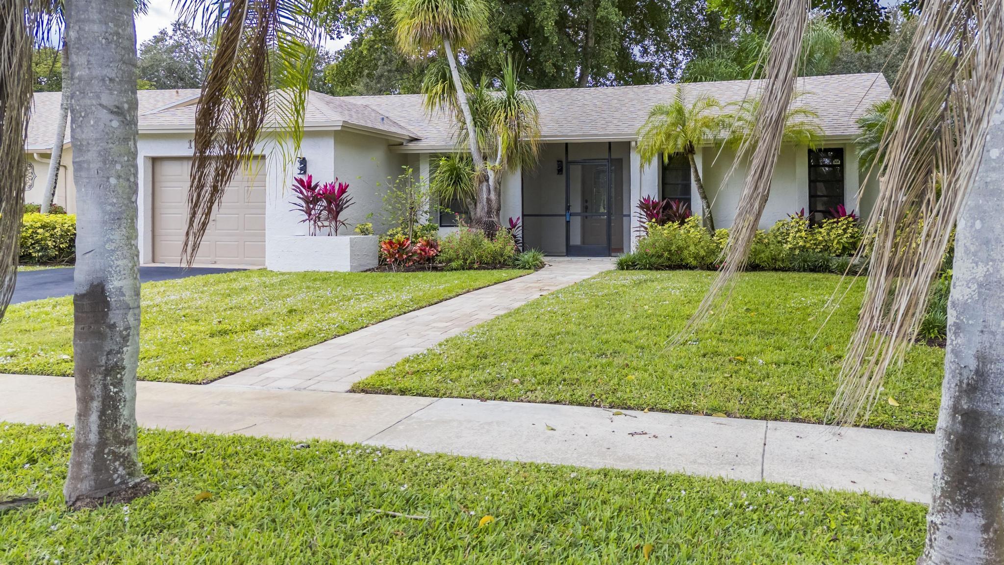18089 103rd Trail South Boca Raton, FL 33498 - Photo 43 of 51 a view of a house with a garden and pathway