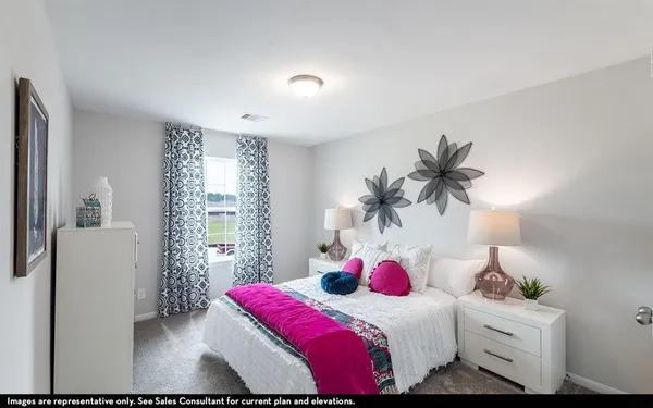 a bedroom with a bed and a potted plant