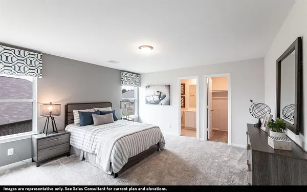 a bedroom with a large bed and a flat tv screen