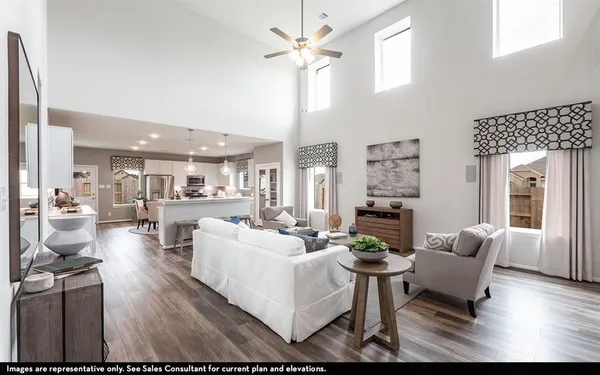 a living room with furniture a fireplace and a chandelier