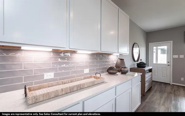 a kitchen with a cabinets and wooden floor