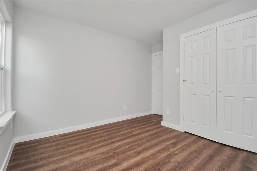 7413 Shotwell Street, Unit A Houston, TX 77028 - Photo 7 of 17 a view of an empty room with wooden floor