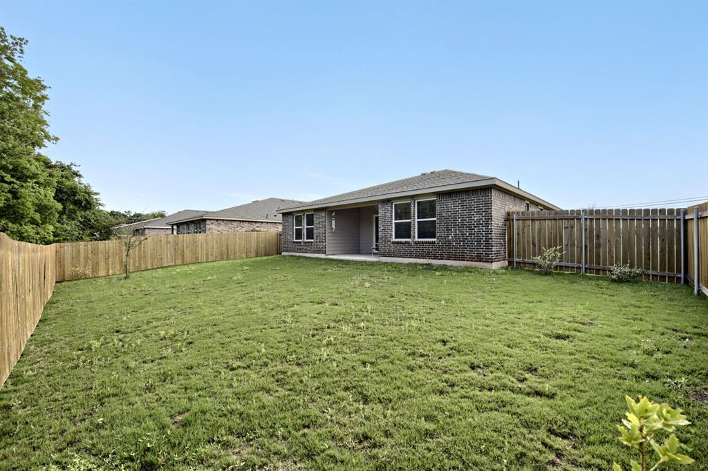 420 Jameson Springtown, TX 76082 - Photo 26 of 29 a backyard of a house with large trees and wooden fence