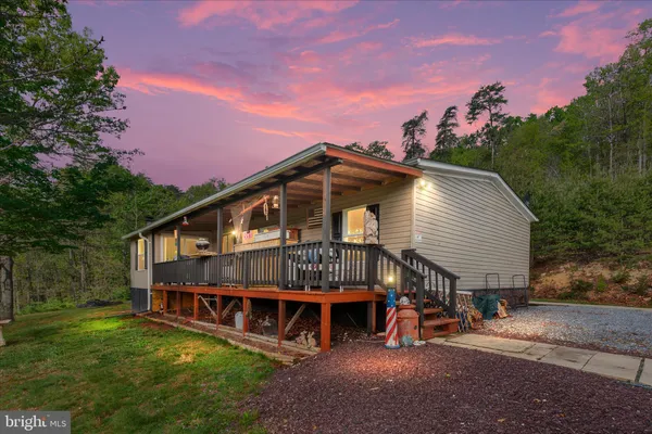 a view of a house with a yard balcony and sitting area