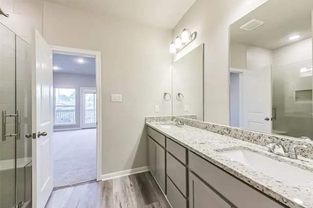 a bathroom with a granite countertop sink mirror and vanity