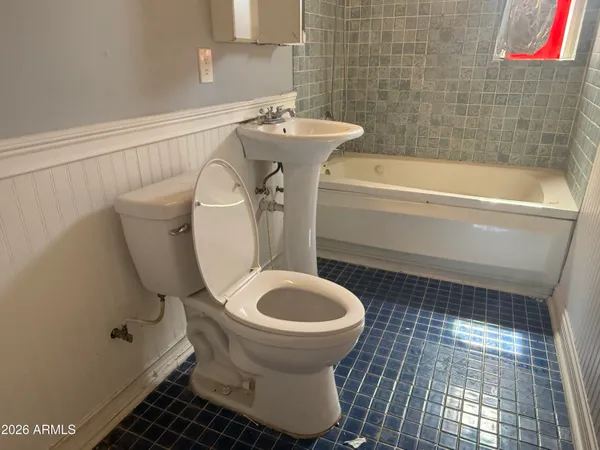 a bathroom with a sink toilet and bathtub
