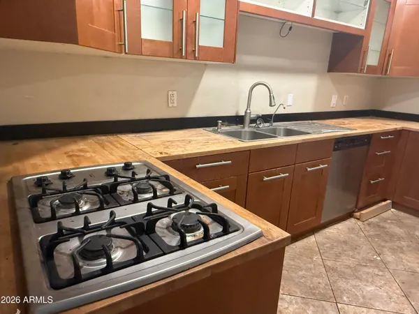 a kitchen with sink a refrigerator and cabinets