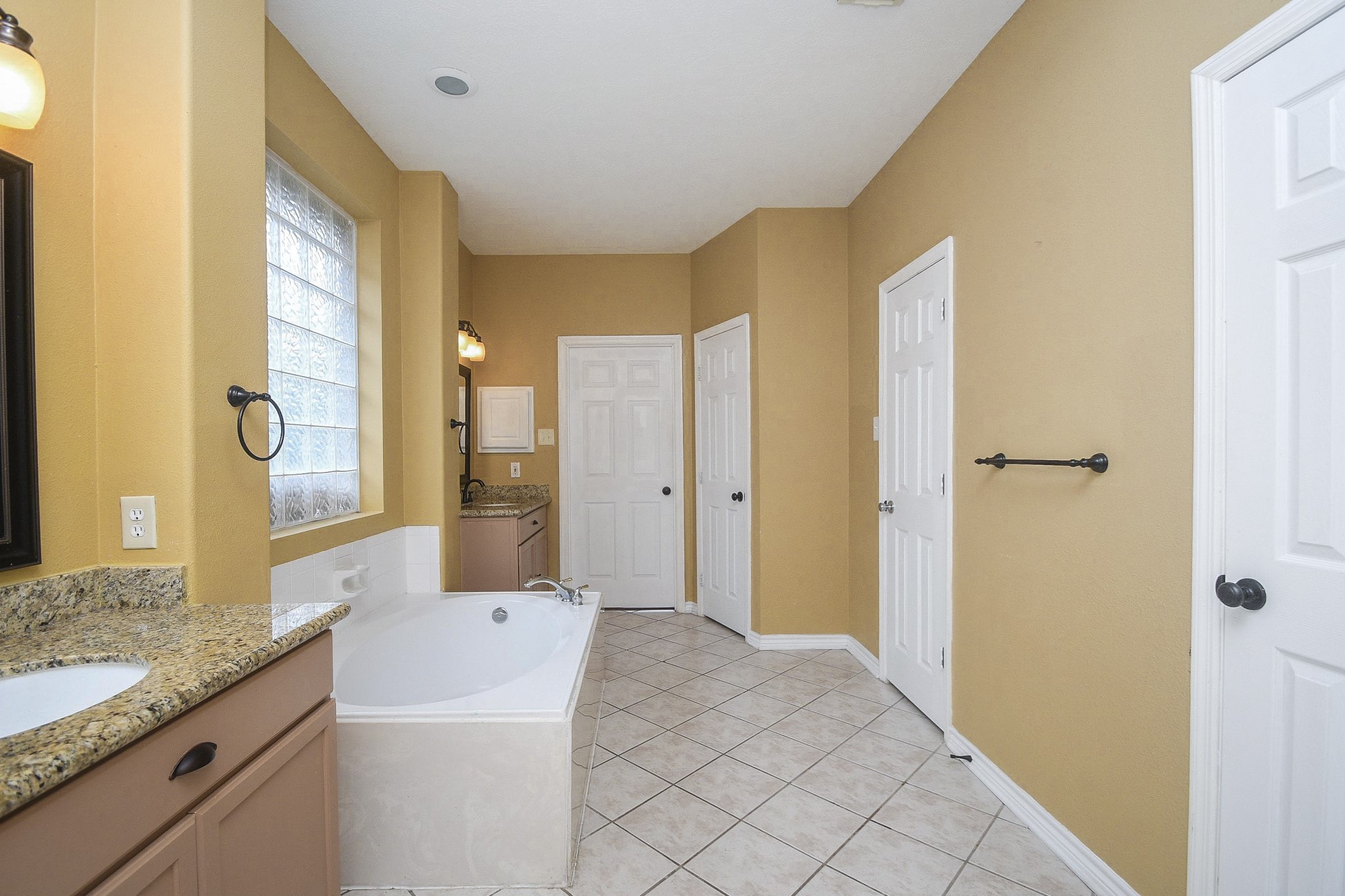 5602 Walkabout Way Katy, TX 77450 - Photo 22 of 33 a bath room with a granite countertop sink and a mirror