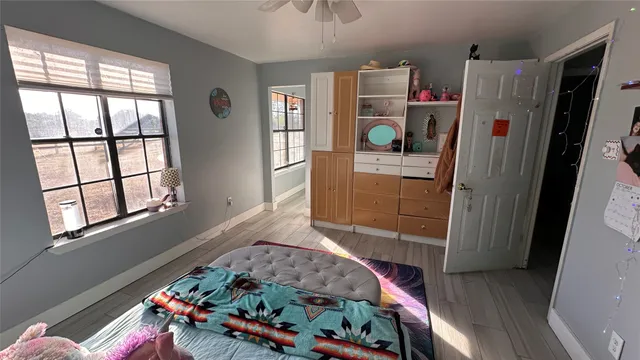 a bedroom with furniture and a wooden floor