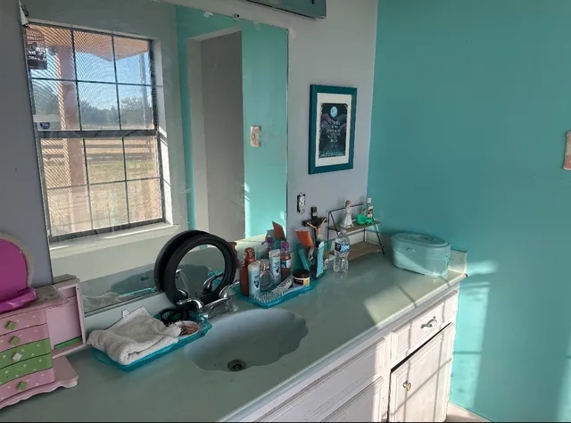 a kitchen with a sink cabinets and a window