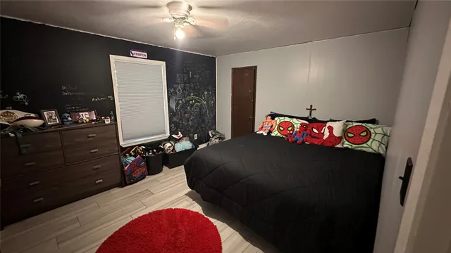 a bedroom with a bed and a dresser