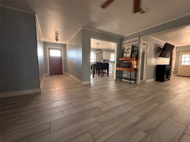 a view of a livingroom with furniture and an empty room