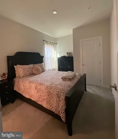 a bedroom with a bed and a night stand