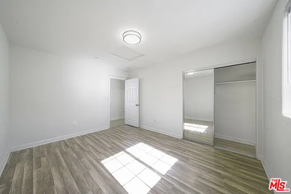 a view of wooden floor and windows in a room