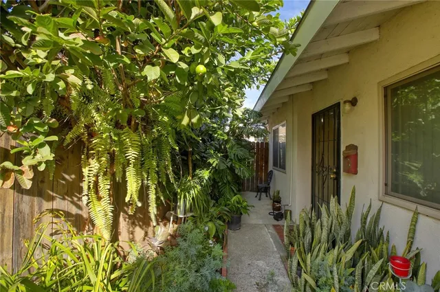 a yellow vase with trees in front of it