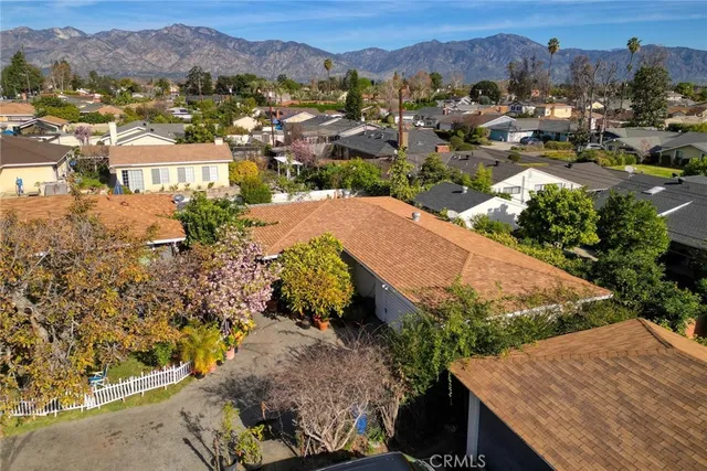 an aerial view of residential houses with outdoor space