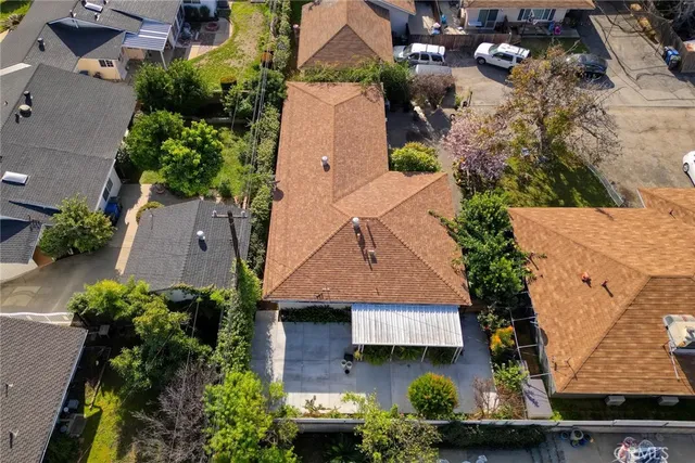 an aerial view of a house with a yard