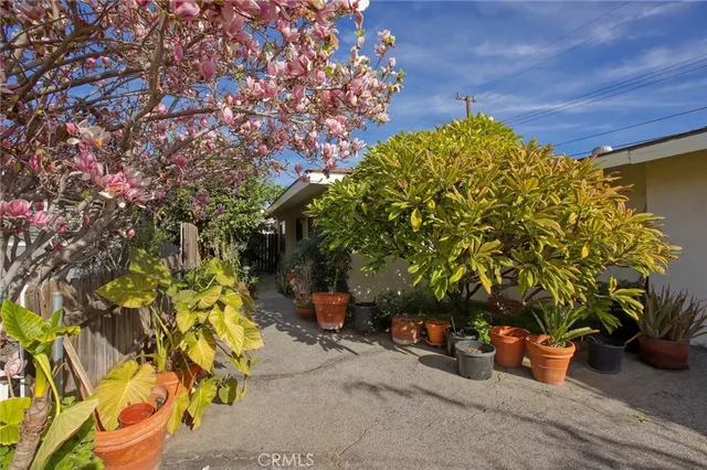 a backyard of a house with table and chairs