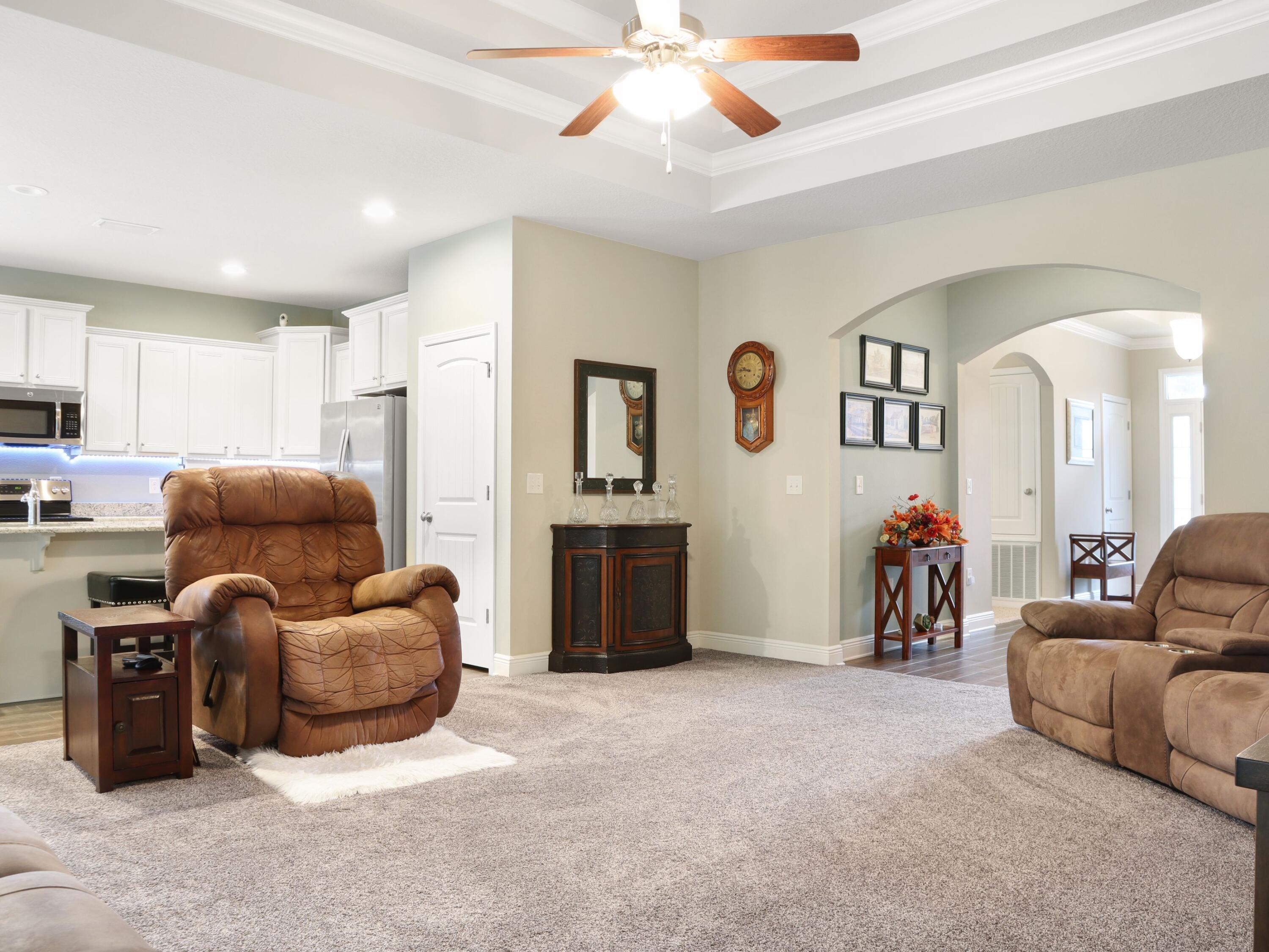 4753 Dupont Circle Pace, FL 32571 - Photo 11 of 42 a living room with furniture and a flat screen tv