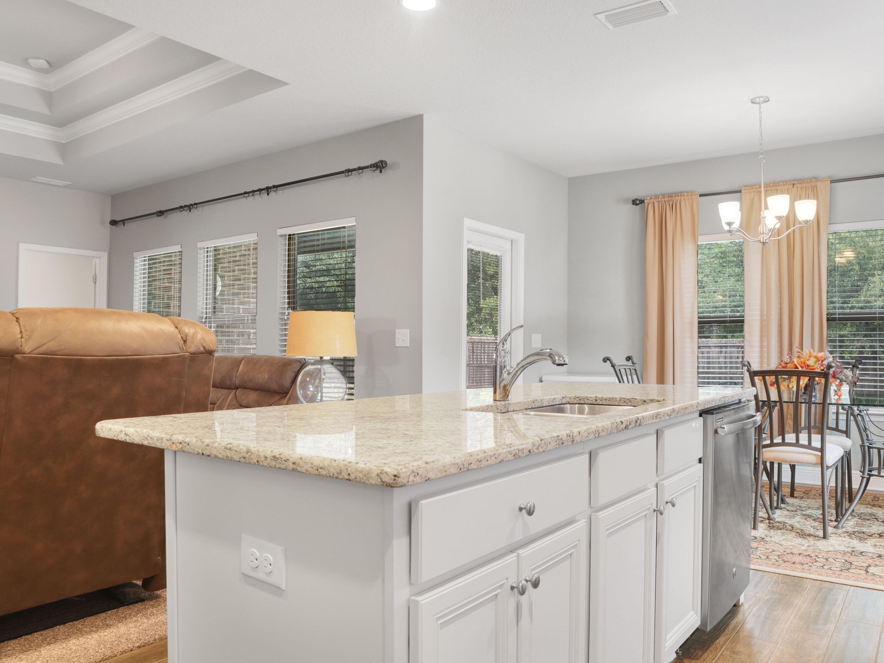 4753 Dupont Circle Pace, FL 32571 - Photo 13 of 42 a kitchen with center island and windows