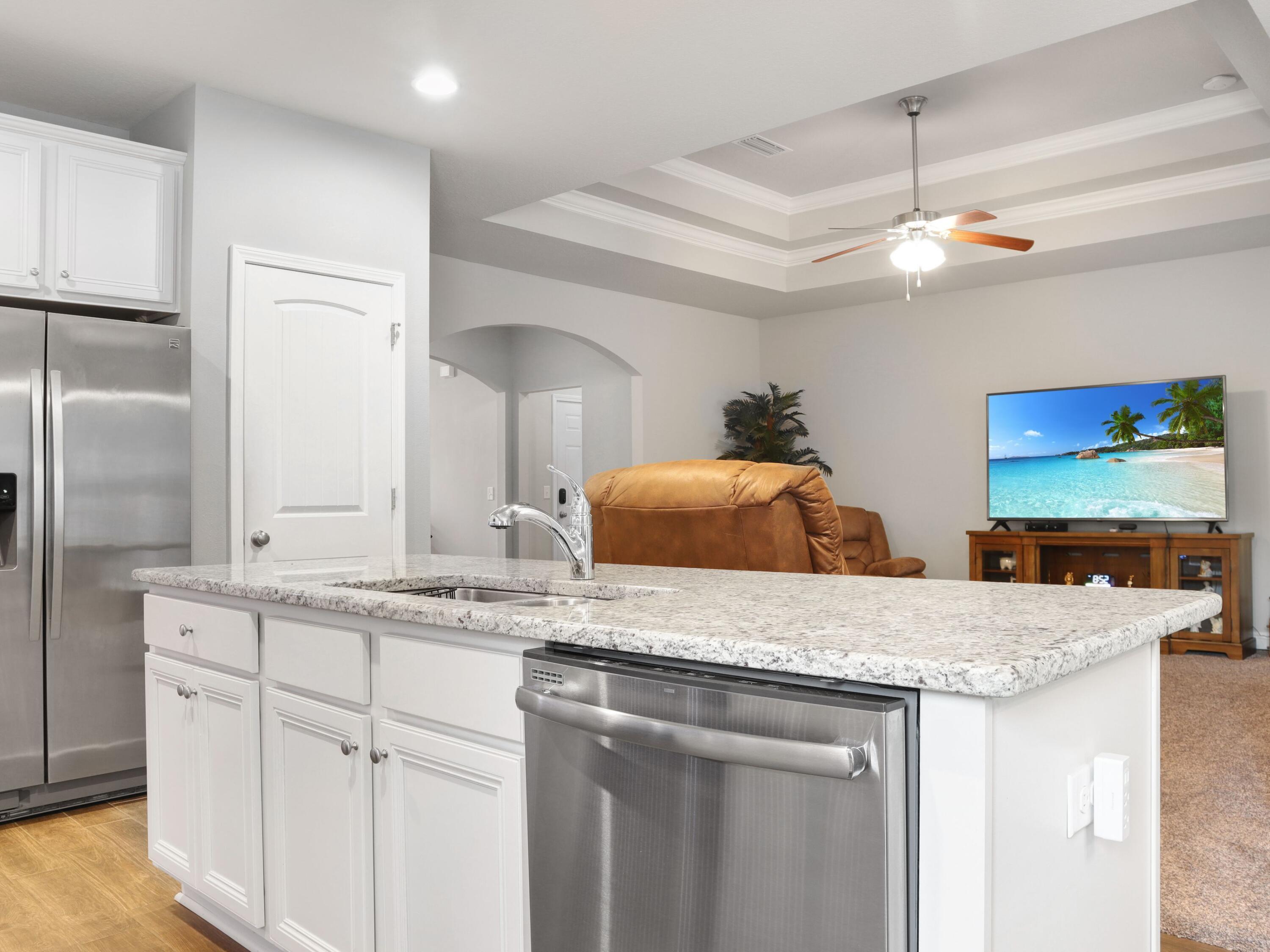 4753 Dupont Circle Pace, FL 32571 - Photo 14 of 42 a kitchen with kitchen island granite countertop a sink and refrigerator