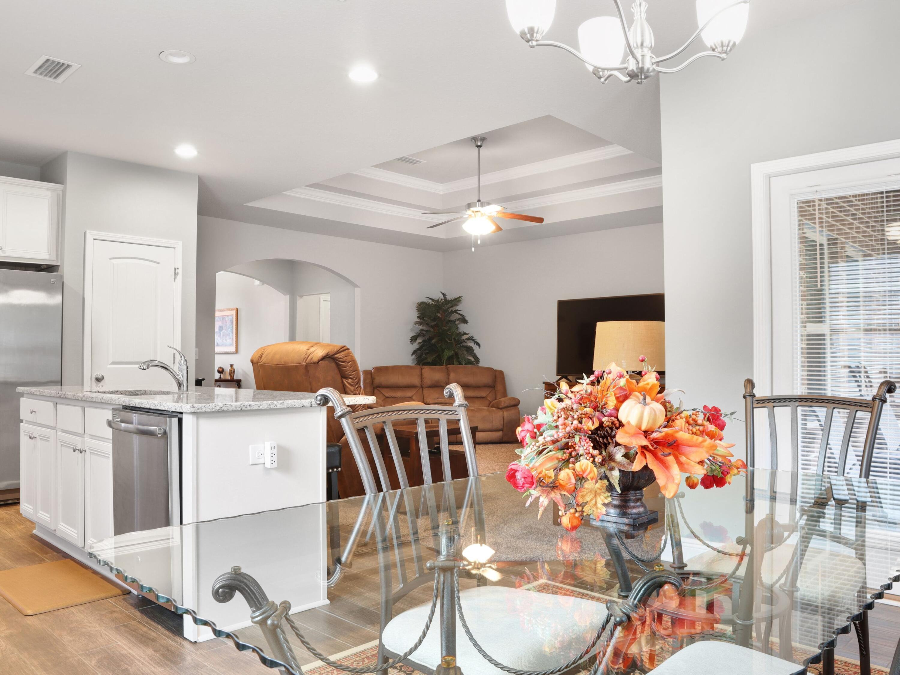 4753 Dupont Circle Pace, FL 32571 - Photo 18 of 42 a dining room with furniture a chandelier and kitchen view