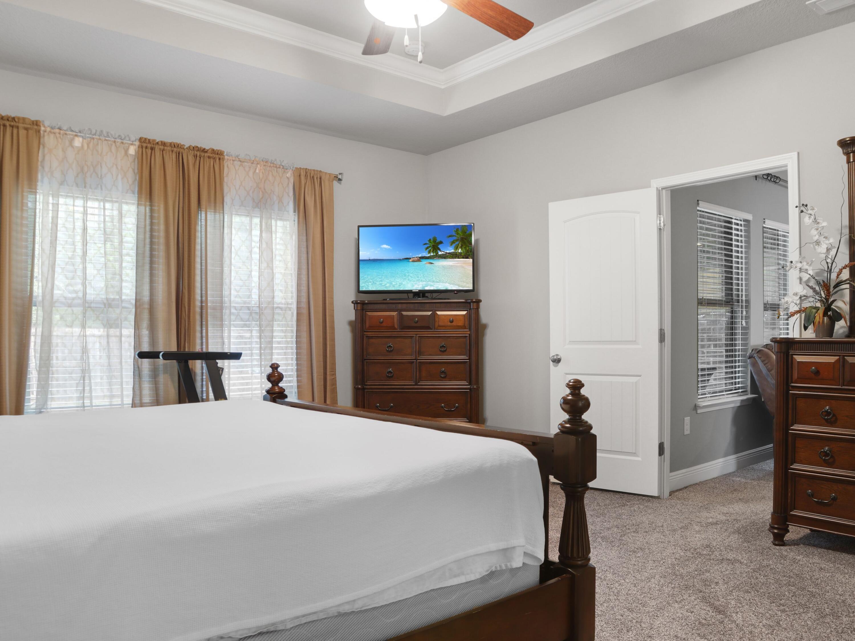 4753 Dupont Circle Pace, FL 32571 - Photo 22 of 42 a bedroom with a bed and a cabinets