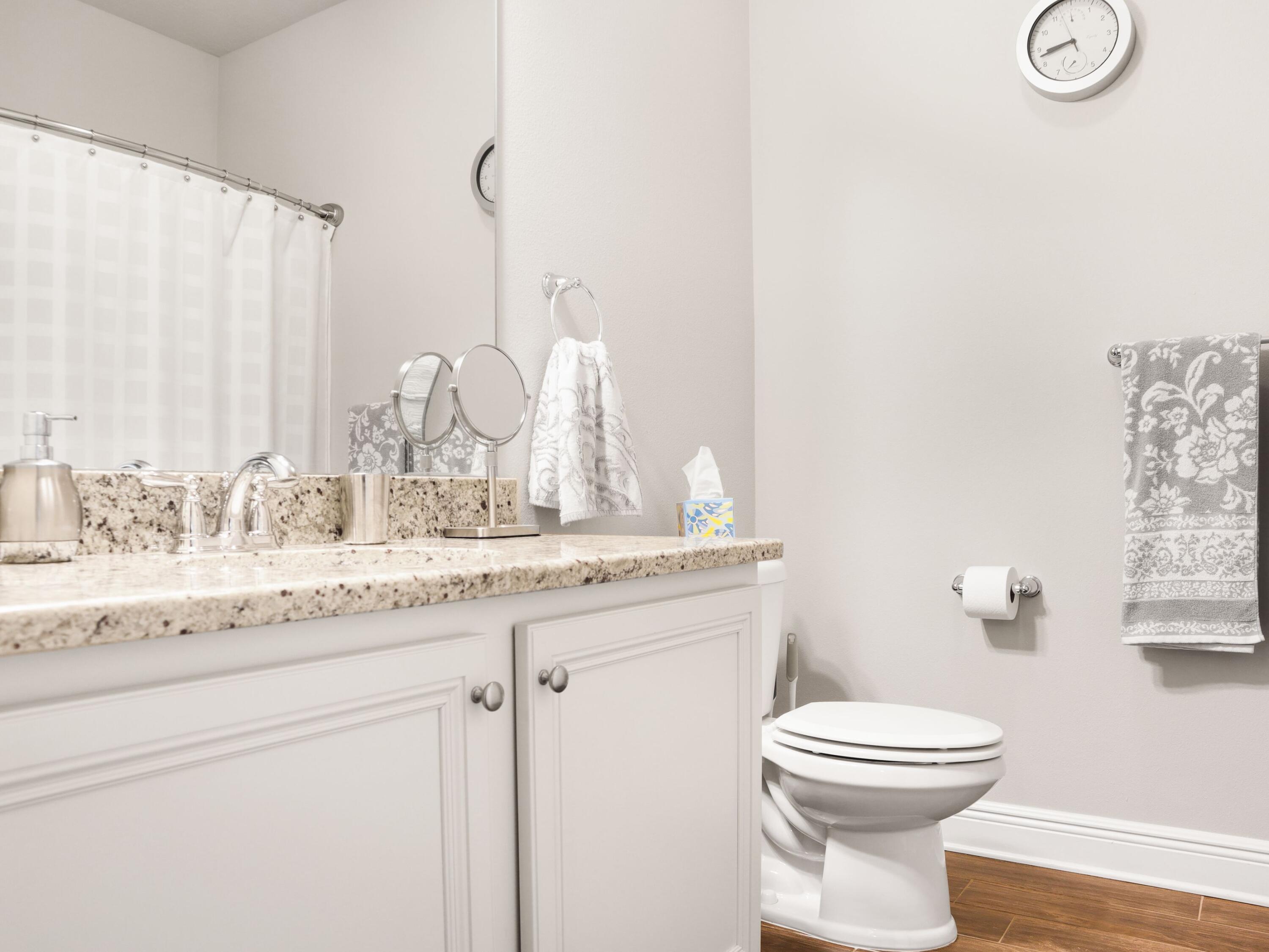 4753 Dupont Circle Pace, FL 32571 - Photo 30 of 42 a bathroom with a granite countertop sink mirror vanity and toilet