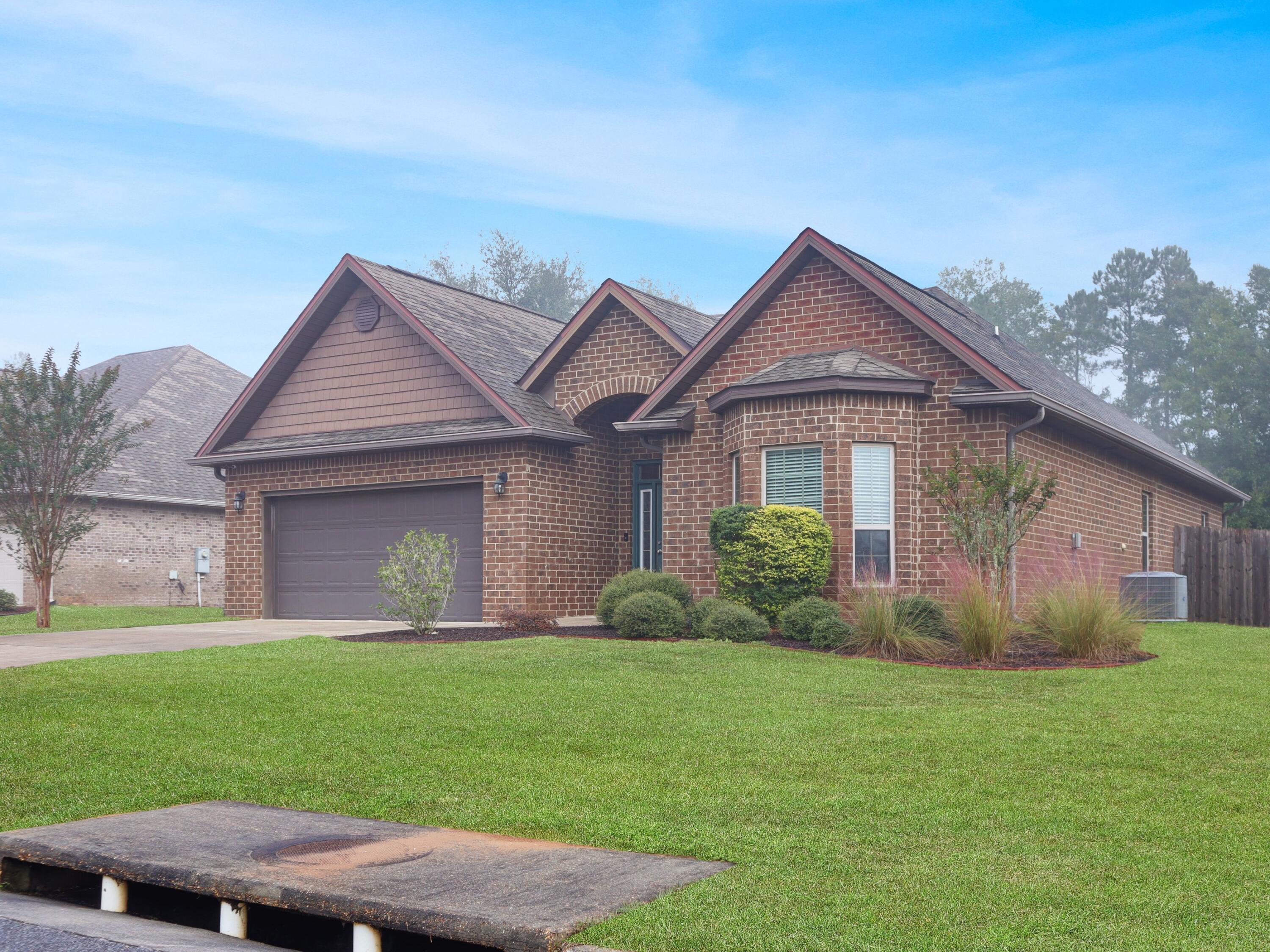4753 Dupont Circle Pace, FL 32571 - Photo 3 of 42 a front view of a house with garden