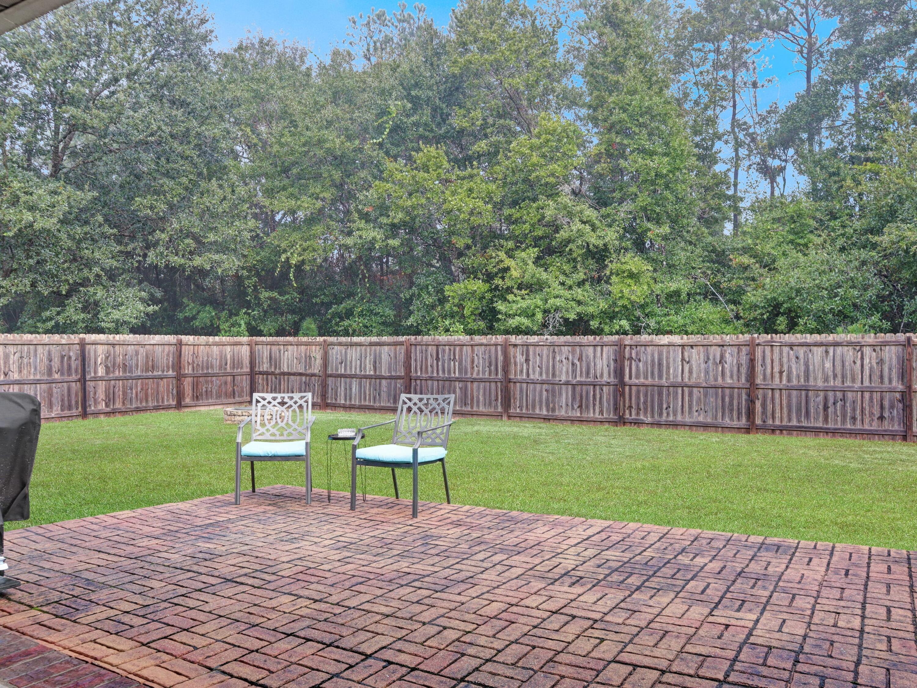 4753 Dupont Circle Pace, FL 32571 - Photo 36 of 42 a view of a chair and table on the wooden floor