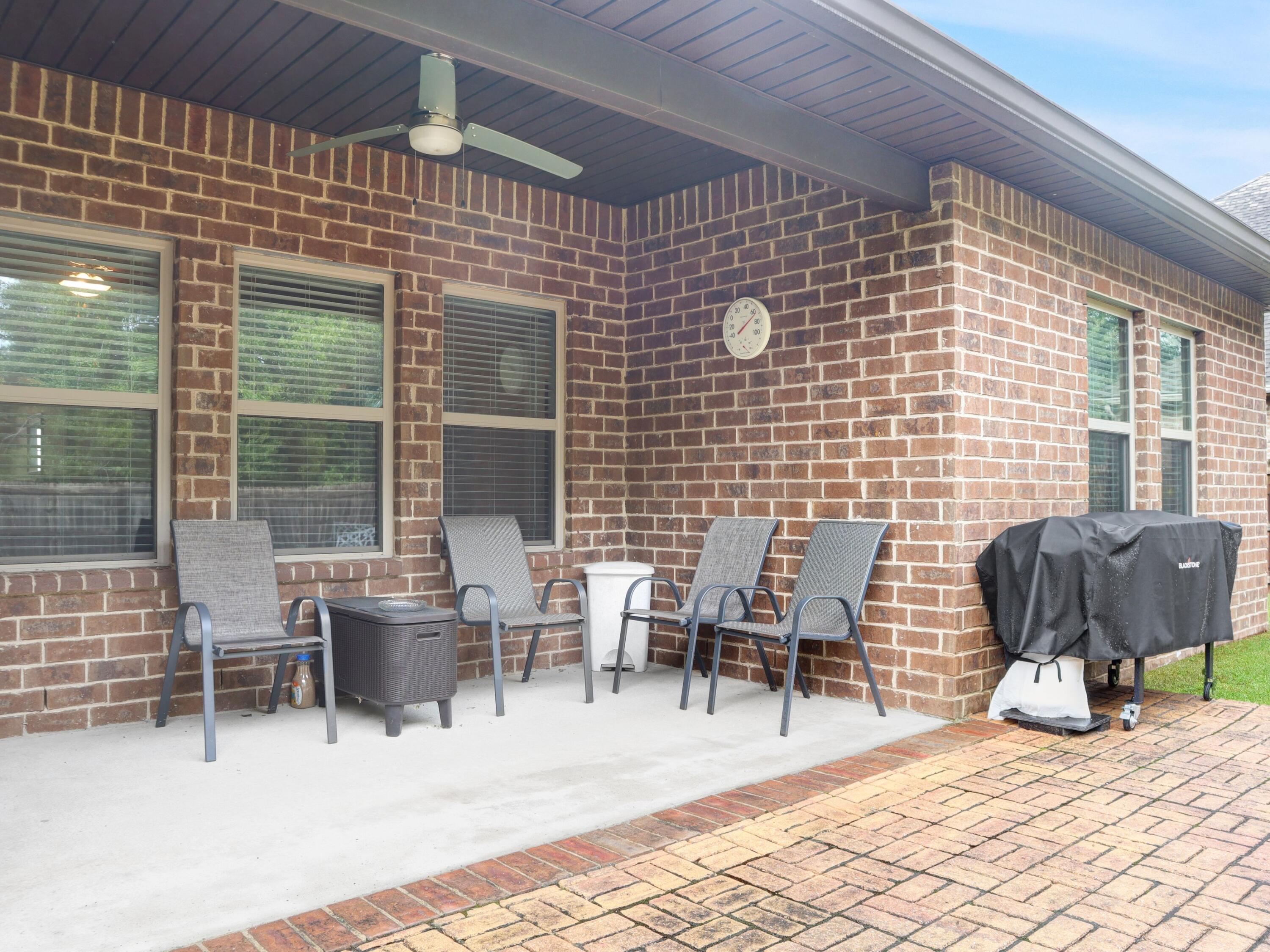 4753 Dupont Circle Pace, FL 32571 - Photo 38 of 42 a patio with table and chairs