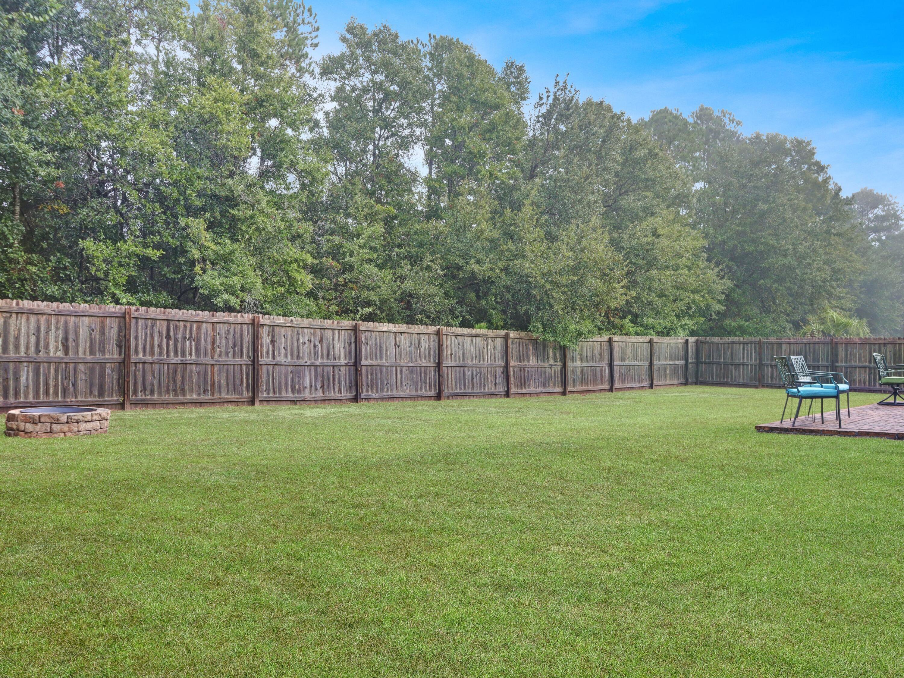 4753 Dupont Circle Pace, FL 32571 - Photo 39 of 42 a view of a backyard with wooden fence