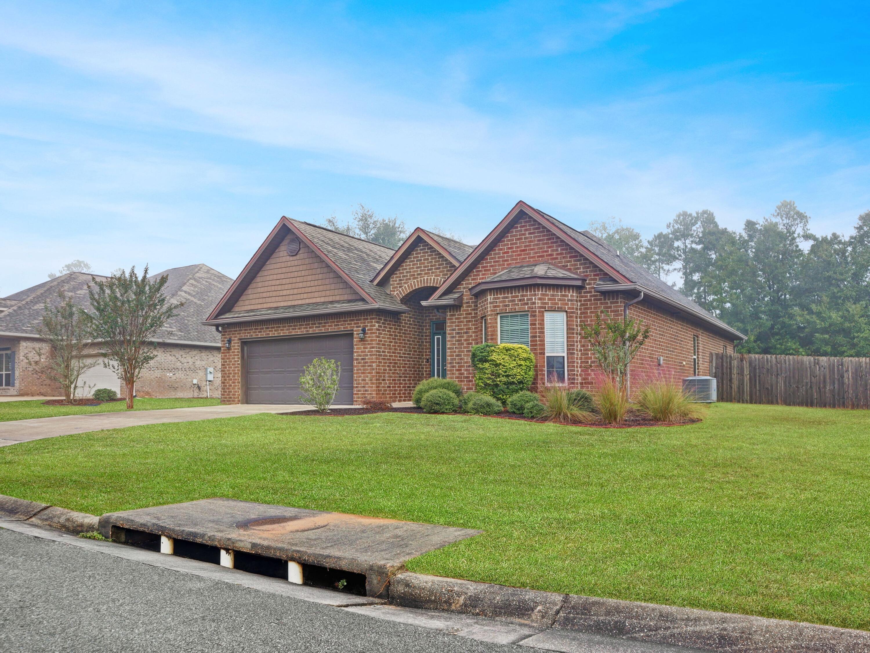 4753 Dupont Circle Pace, FL 32571 - Photo 4 of 42 a view of a house with a yard and pathway